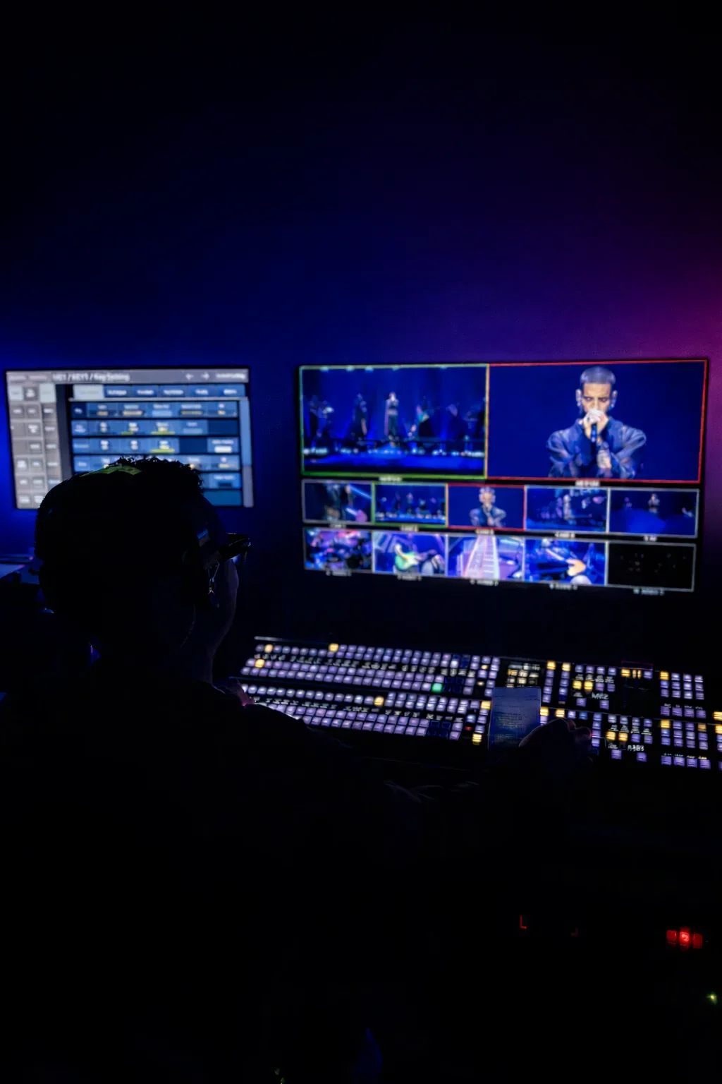 A live video director monitoring multiple camera feeds during a performance.