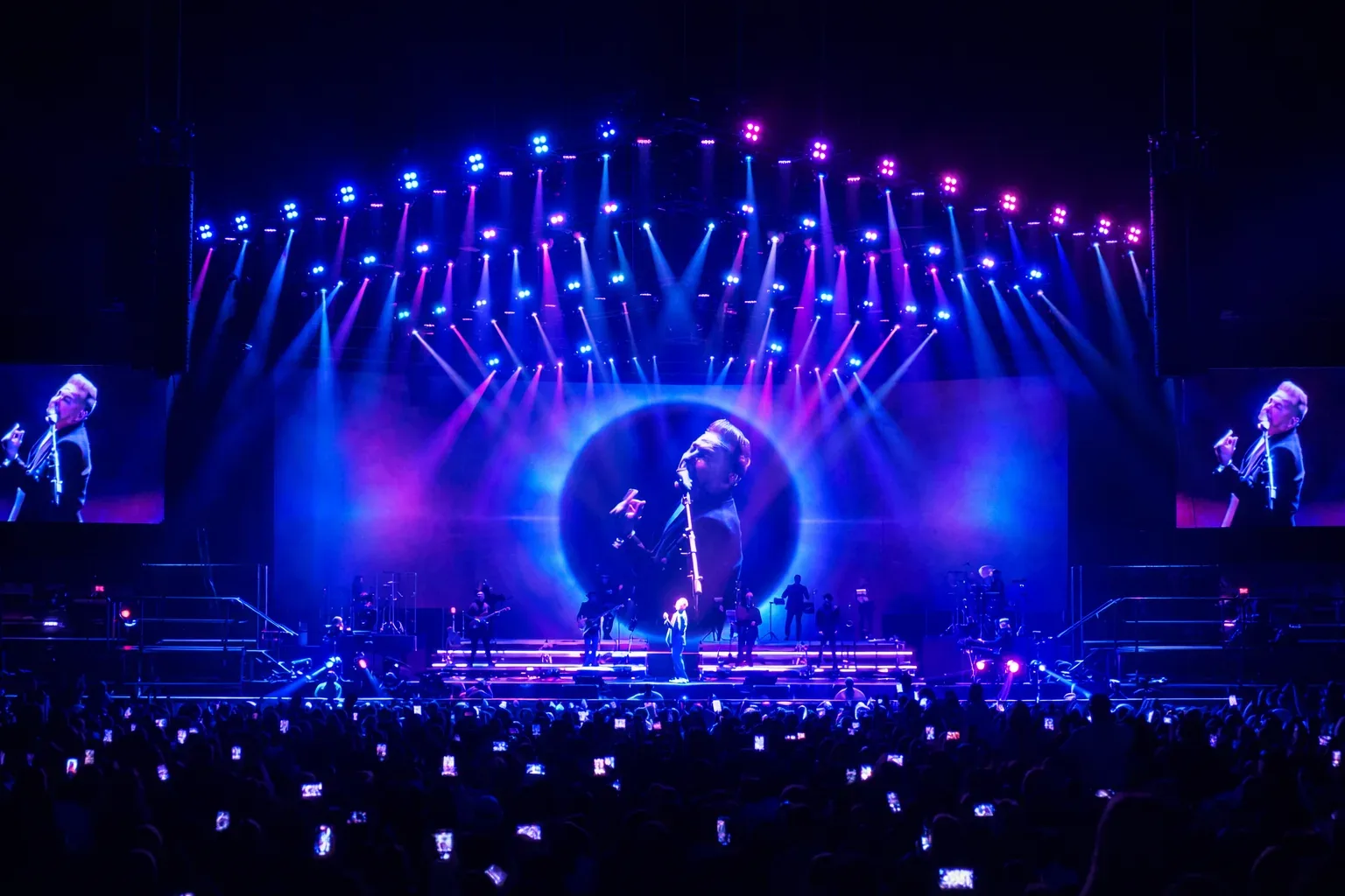 Large-format visual content filling the screens of a live concert stage.