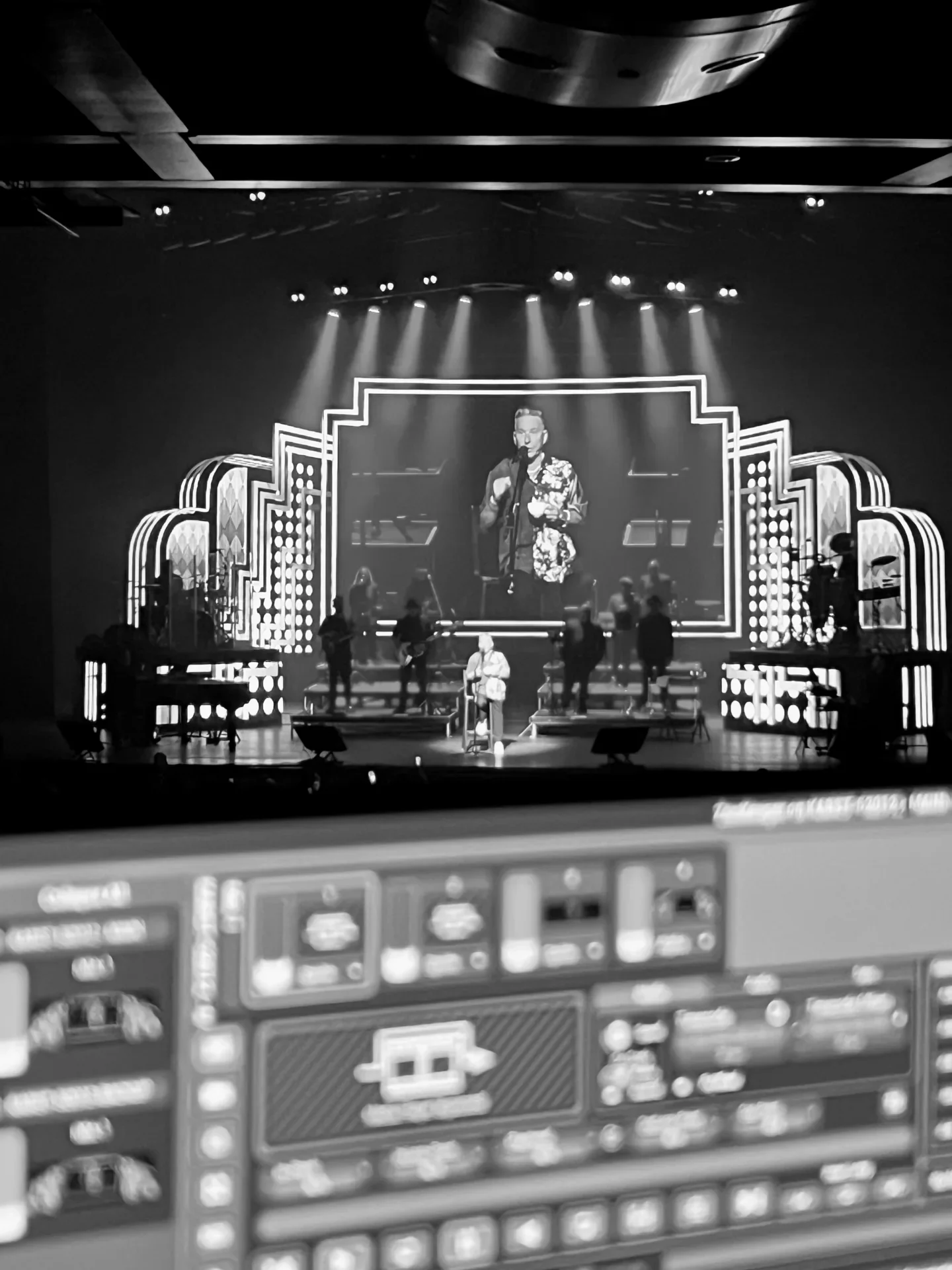 A monochrome live stage viewed from a visual-control position.